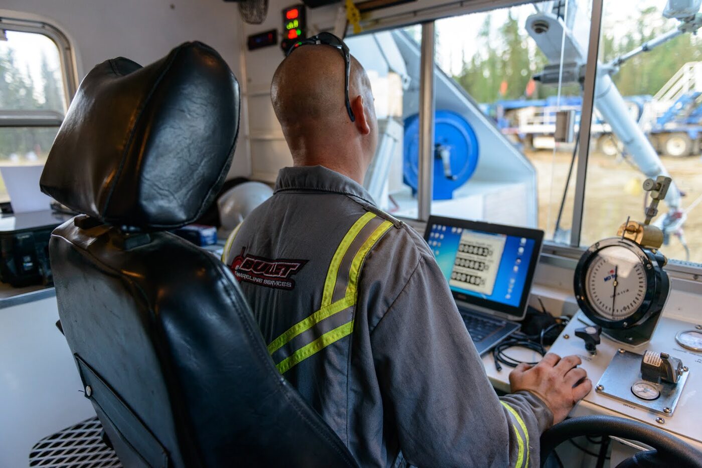 Bullet Wireline operator monitoring a slickline job from inside the unit