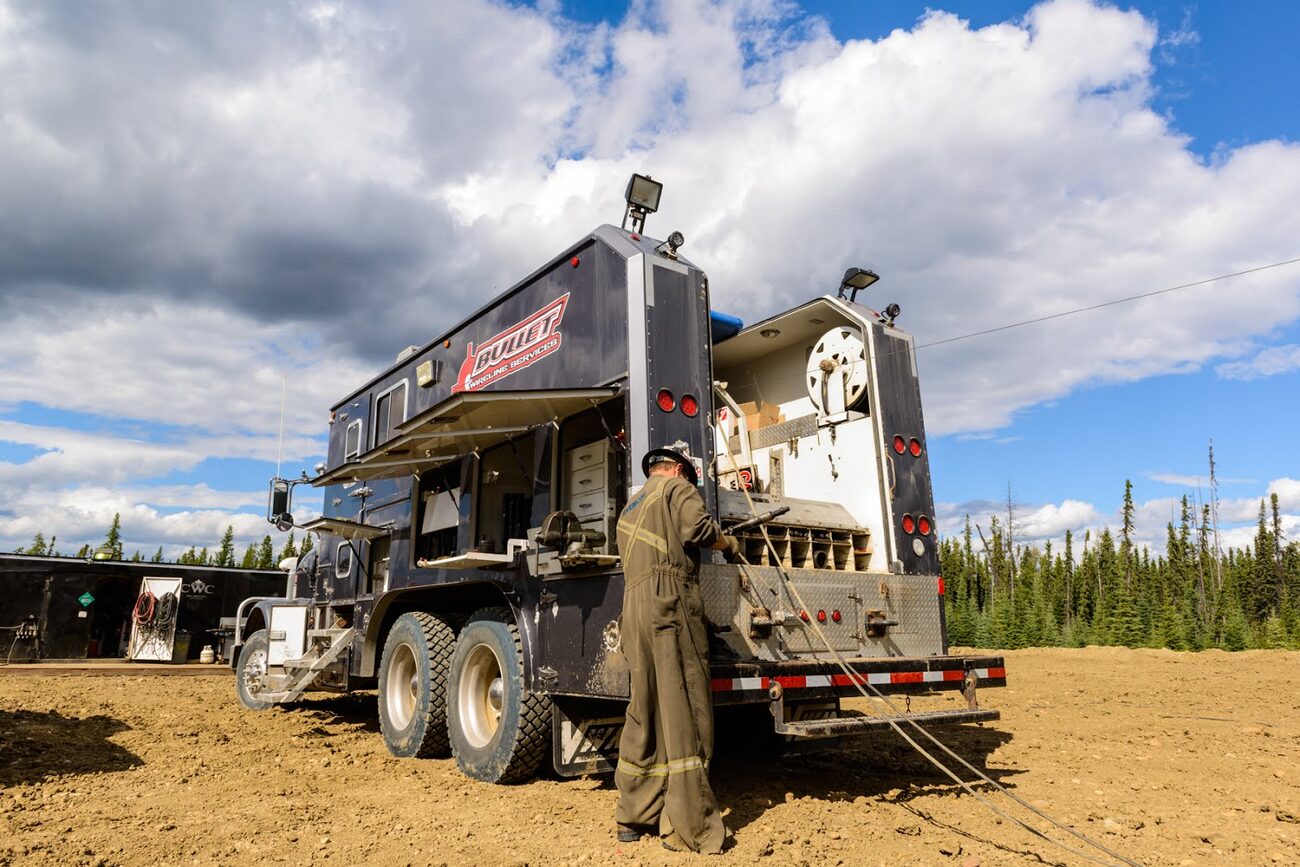 Operator working at the rear of a Bullet Wireline unit on location