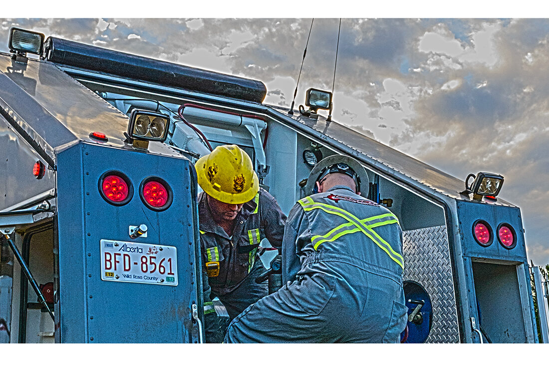 Bullet Wireline crew working on a unit at dusk